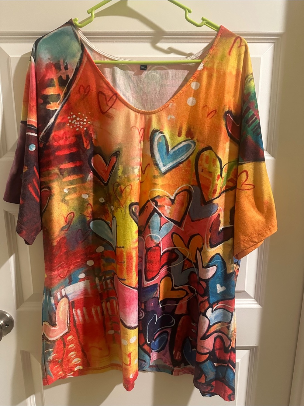 Contemporary casual tunic with colorful heart and abstract geometric pattern.